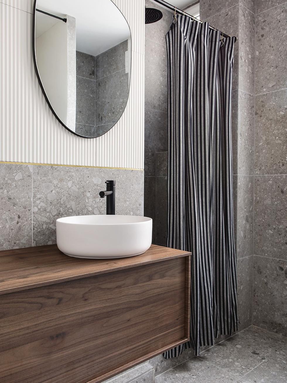 Hanging walnut bathroom cabinet with terrazzo tiles